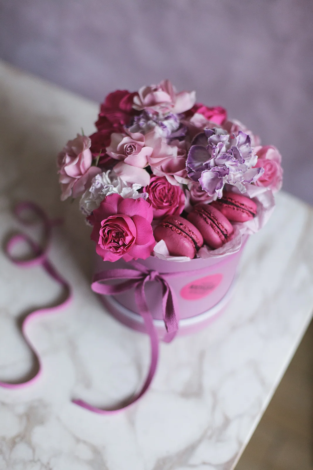 Цветочная композиция из пионовидных роз и пирожных макаронс